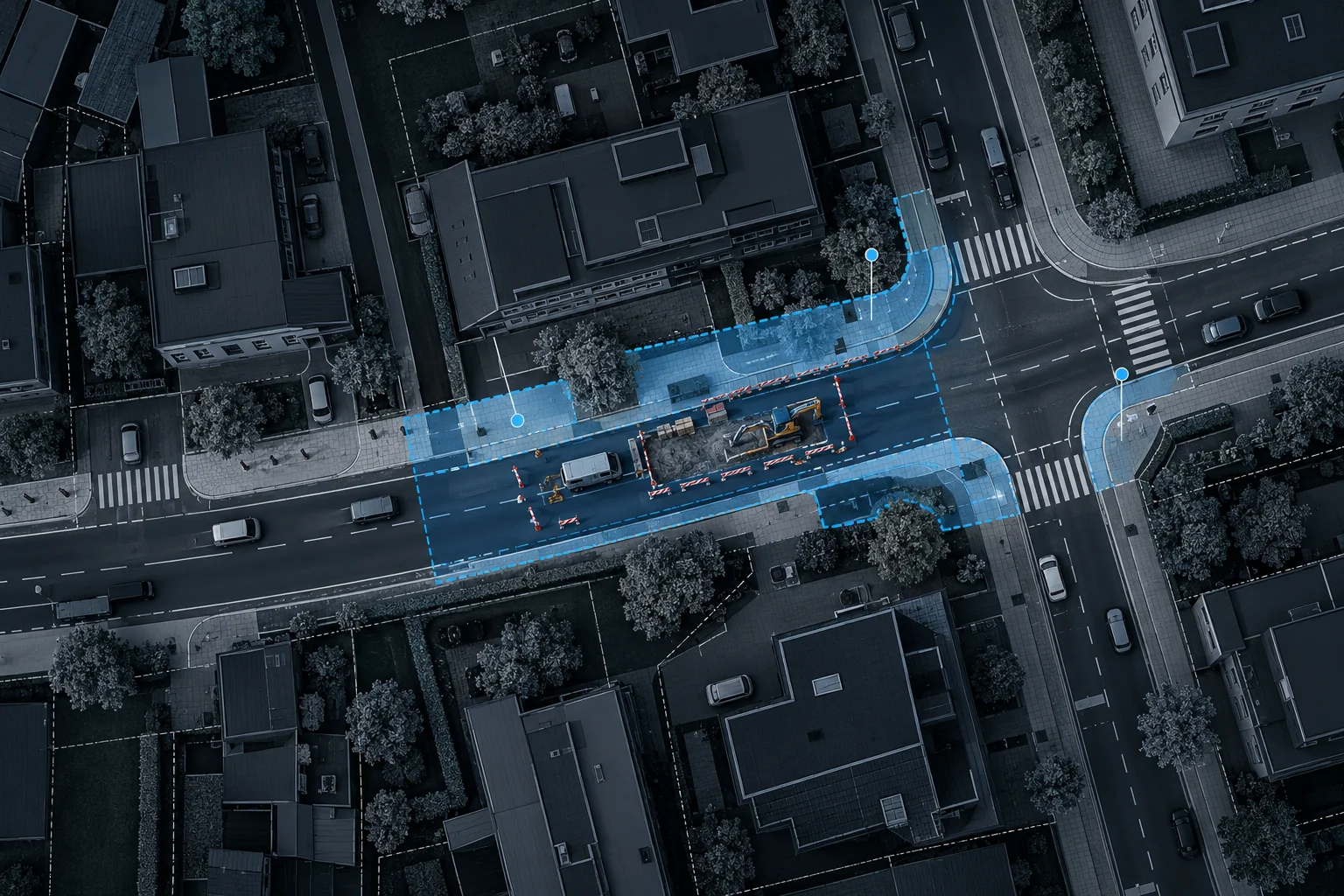 Luftbild einer innerstädtischen Arbeitsstelle, angrenzende Gehwege, Zufahrten und Kreuzungsbereiche sind blau markiert